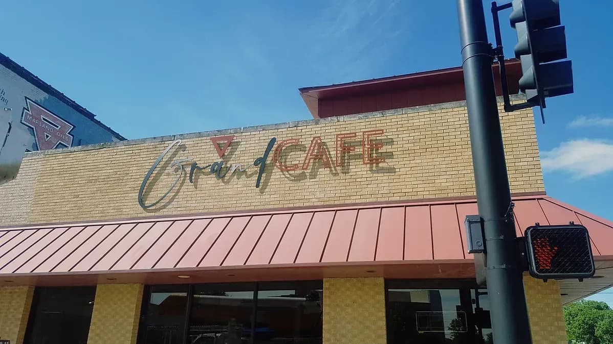 Grand Cafe building sign on brick facade