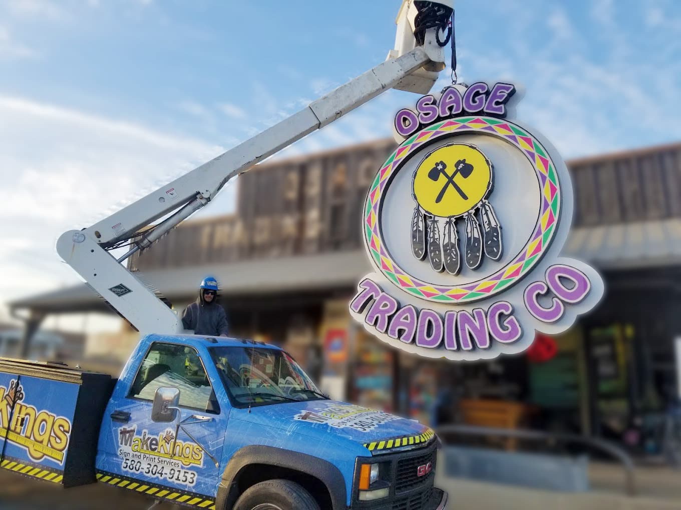 Illuminated Osage Trading Co sign installed by bucket truck